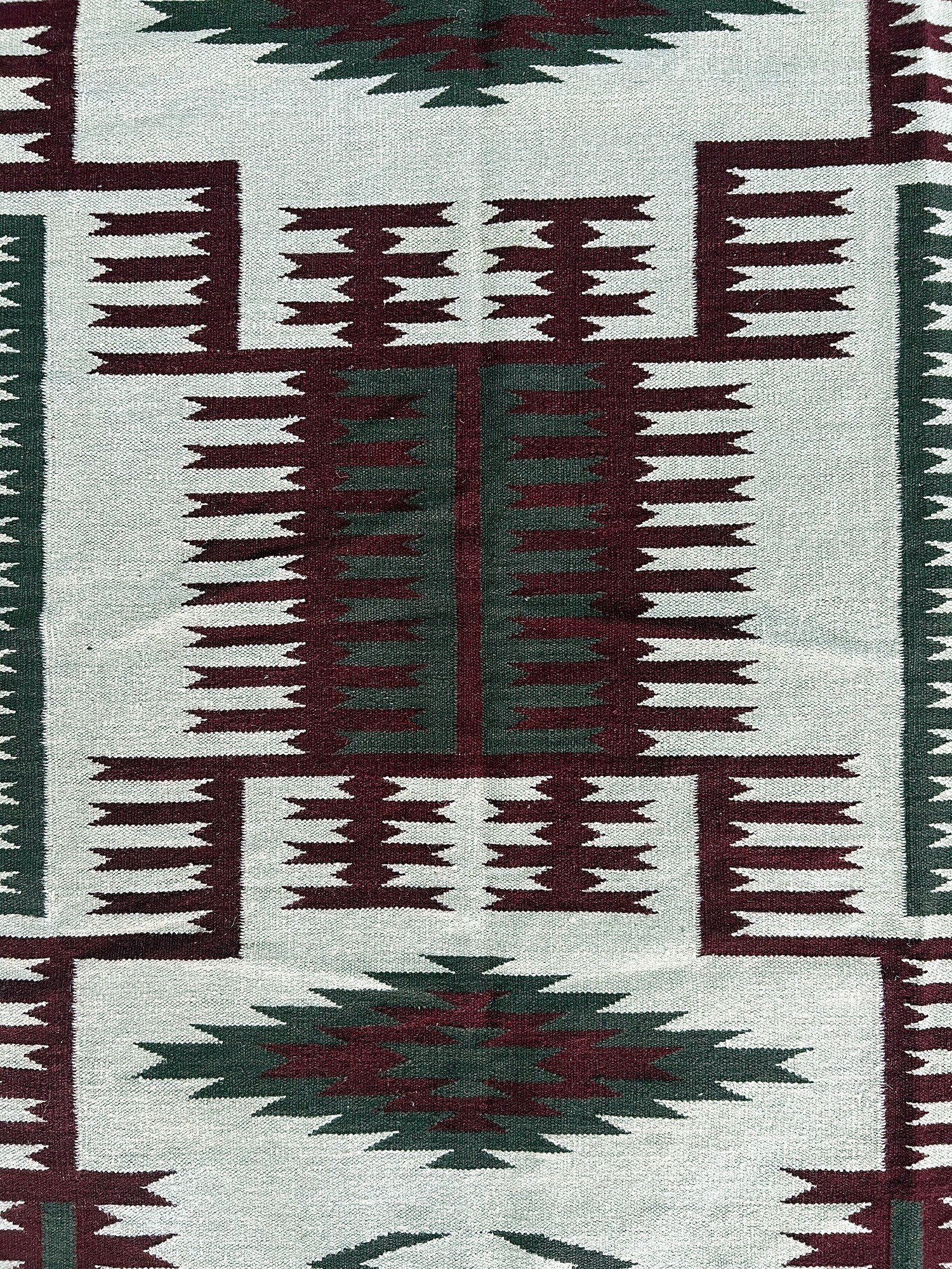 Close-up of the flatweave texture on the ivory kilim runner with maroon and green medallion pattern | The Rugs Curator — Pakistani Premium Rugs