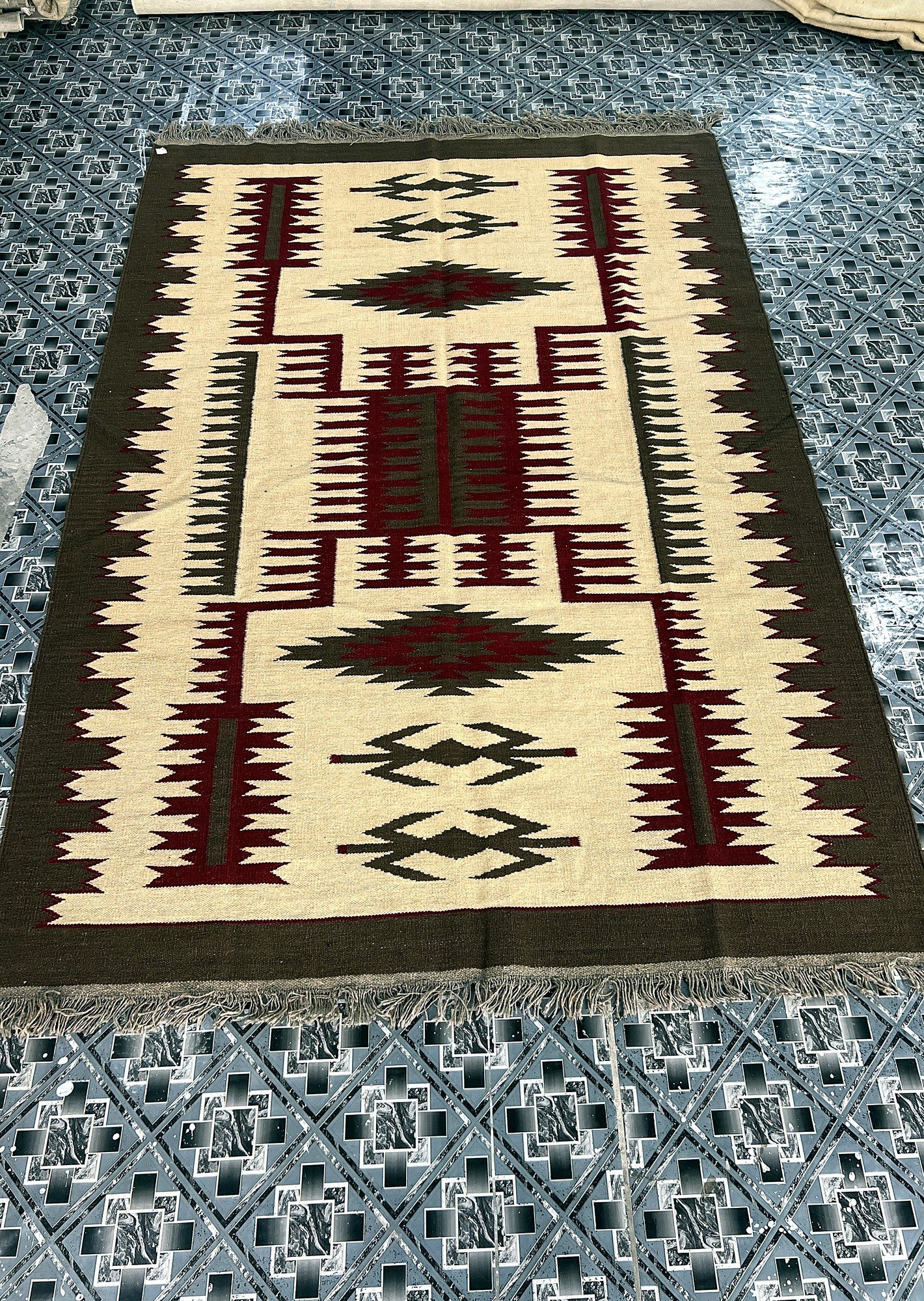 Angled full-length view of the handwoven ivory kilim runner with maroon and green stepped medallions | The Rugs Curator — Pakistani Premium Rugs