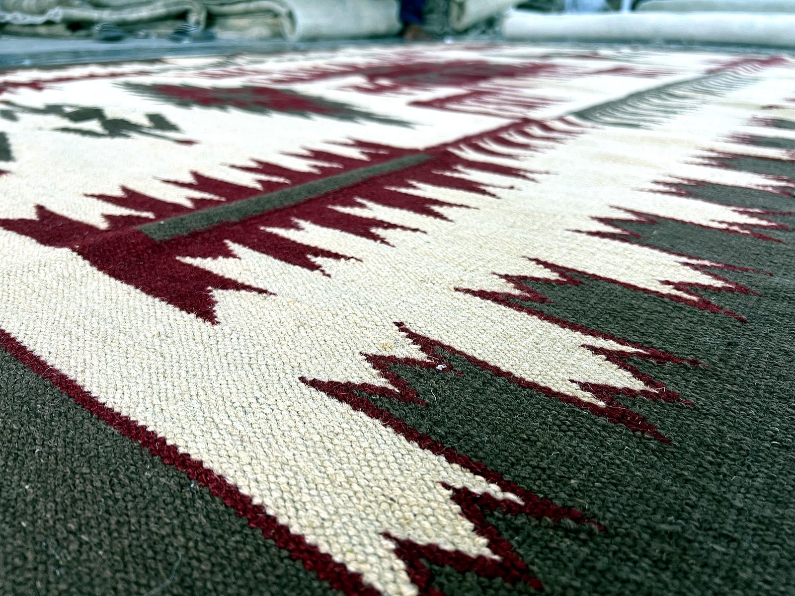 Close-up of the woven fringe and border on the maroon and green medallion kilim runner | The Rugs Curator — Pakistani Premium Rugs