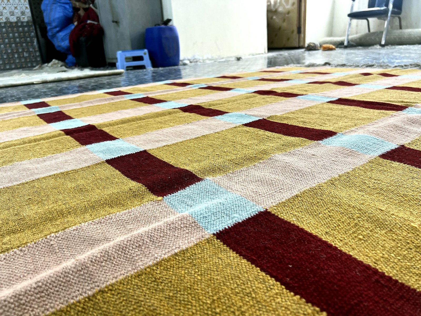 Close-up of the flatweave texture on the mustard and beige windowpane kilim rug | The Rugs Curator — Pakistani Premium Rugs