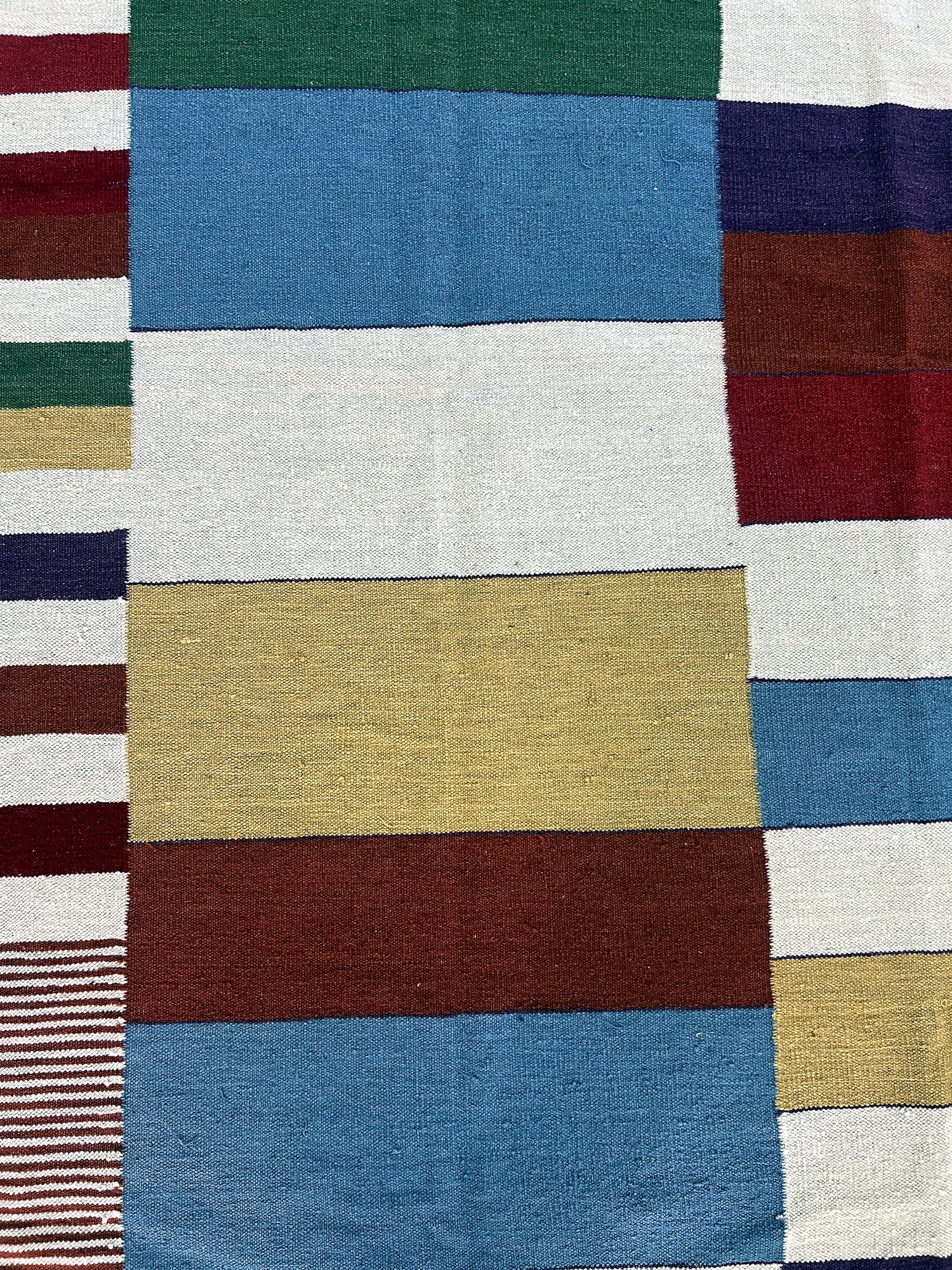 Close-up of the woven fringe and color transitions on the prism patchwork kilim rug | The Rugs Curator — Pakistani Premium Rugs