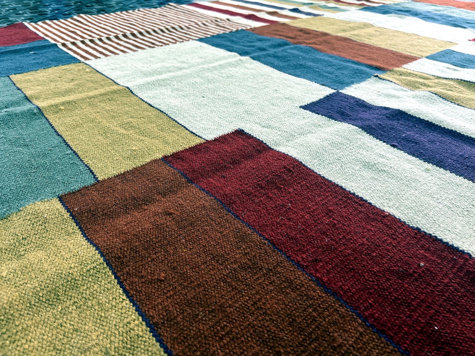 Close-up of the flatweave texture and color blocks on the multicolor patchwork kilim rug | The Rugs Curator — Pakistani Premium Rugs