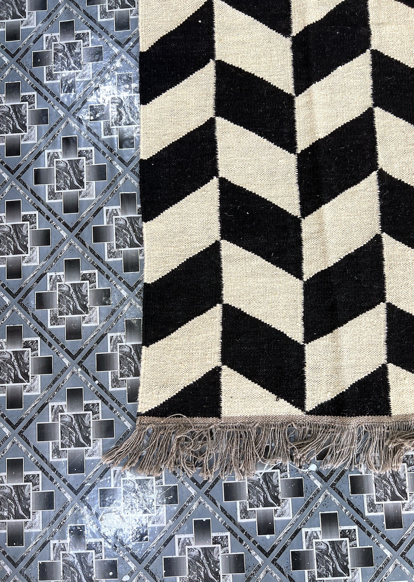 Close-up of the chevron pattern and fringe edge on the black and ivory herringbone kilim rug | The Rugs Curator — Pakistani Premium Rugs